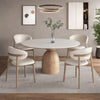 Oak Inside Dining room with a round wooden table and white chairs on a gray rug.